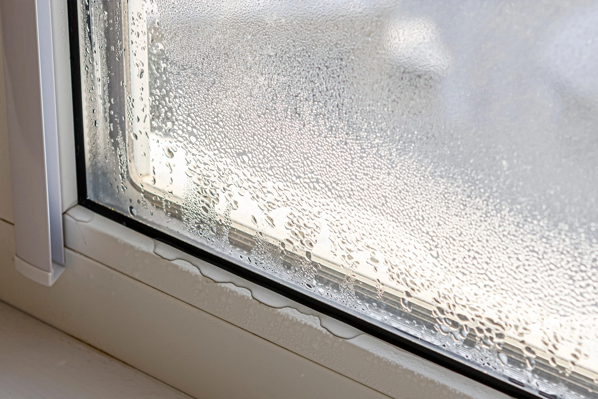 Impact window in a humid Florida home being checked for condensation and fogging