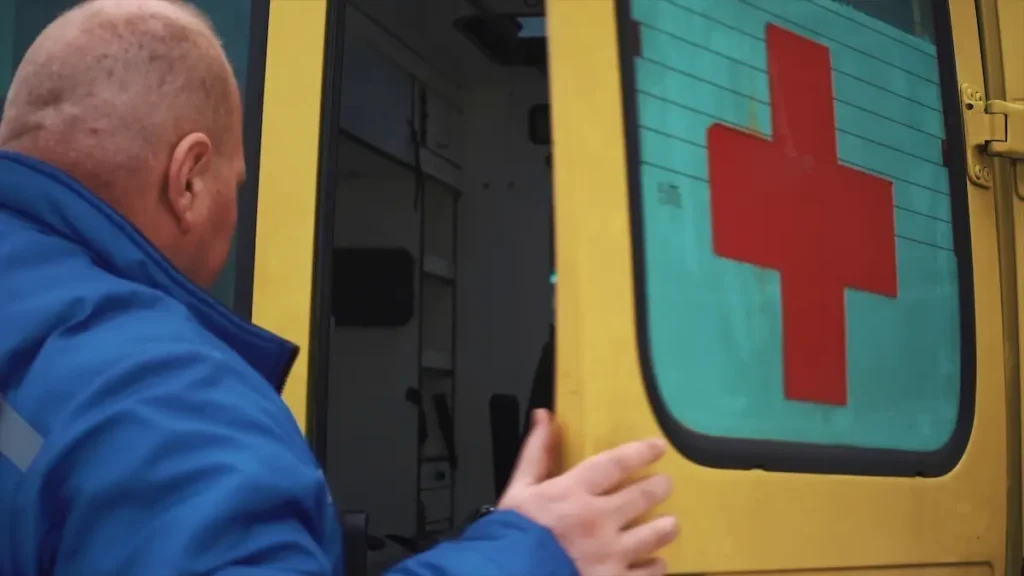team provide first aid on the street stock image